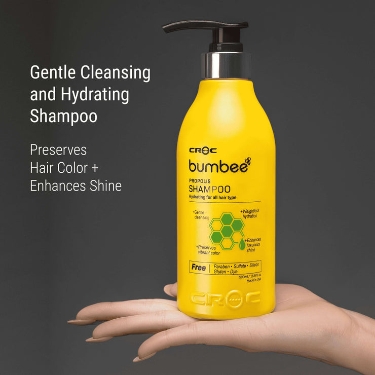 Hand presenting Bumbee Propolis Shampoo, 500ml, with a gentle and hydrating formula, perfect for preserving hair color and boosting shine, free from harsh chemicals.