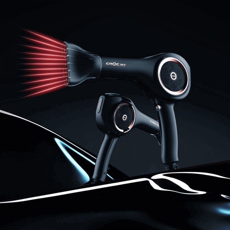 A blow dryer is displayed in a stylized black gradient background. Red rays are coming out of the blow dryer&